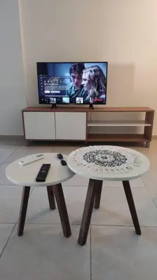 a living room with two tables and a tv at departamento de dos dormitorios in Cordoba