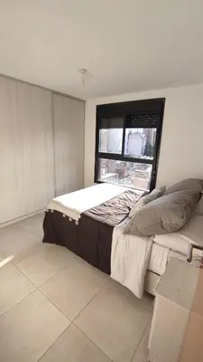 a bedroom with a large bed and a window at departamento de dos dormitorios in Cordoba