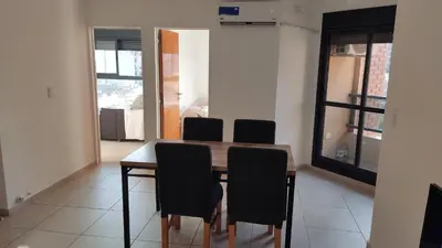 a dining room with a table and four chairs at departamento de dos dormitorios in Cordoba