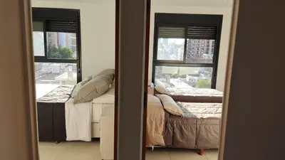 a room with two beds and two windows at departamento de dos dormitorios in Cordoba