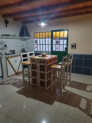 a kitchen with a table and chairs in a room at La Casona de Cerro Colonial in Trapiche