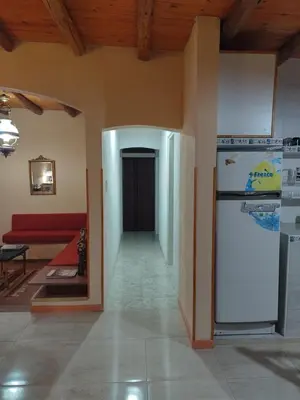 a living room with a refrigerator and a couch at La Casona de Cerro Colonial in Trapiche