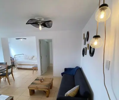 a living room with a blue couch and a ceiling fan at DEPARTAMENTO ANTIGUA CERVECERIA in Cordoba