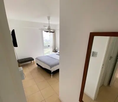 a bedroom with a bed and a mirror at DEPARTAMENTO ANTIGUA CERVECERIA in Cordoba