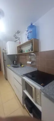 a kitchen with a stove and a counter top at DEPARTAMENTO ANTIGUA CERVECERIA in Cordoba