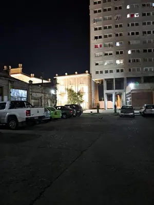 a parking lot with cars parked in front of a building at DEPARTAMENTO ANTIGUA CERVECERIA in Cordoba