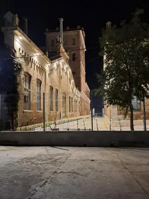 a large brick building with lights on it at night at DEPARTAMENTO ANTIGUA CERVECERIA in Cordoba