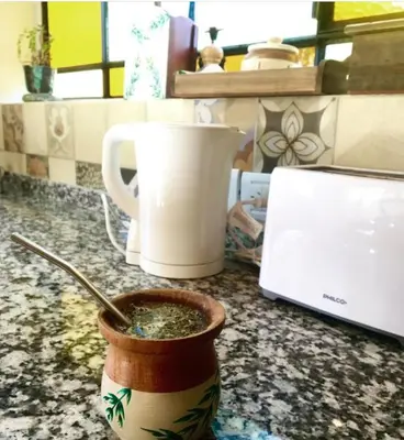 a cup of soup on a counter next to a laptop at Color Local Cabañas in San Javier