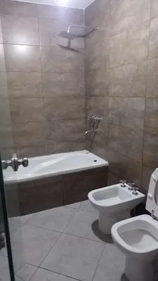 a bathroom with a bath tub and a toilet at Lake360 Dto 51 in Villa Carlos Paz