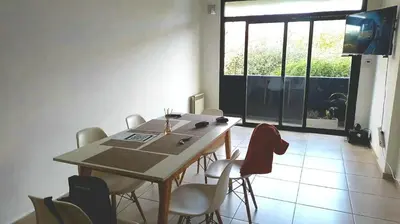 a dining room with a table and chairs and a window at Lake360 Dto 51 in Villa Carlos Paz