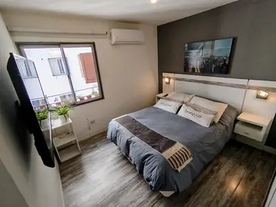 a bedroom with a large bed and a window at BV ILLIA TERMINAL DE OMNIBUS in Cordoba