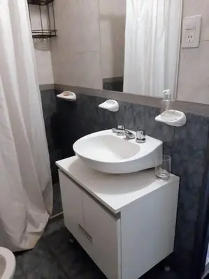 a bathroom with a white sink and a mirror at BV ILLIA TERMINAL DE OMNIBUS in Cordoba