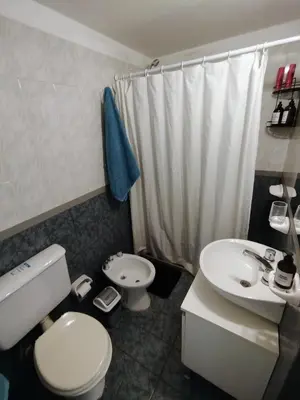 a bathroom with a white toilet and a sink at BV ILLIA TERMINAL DE OMNIBUS in Cordoba