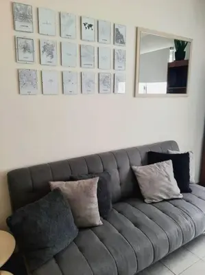 a gray couch with pillows in a living room at BV ILLIA TERMINAL DE OMNIBUS in Cordoba