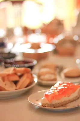 a table with plates of food on a table at Posada Sausalito in Santa Rosa de Calamuchita