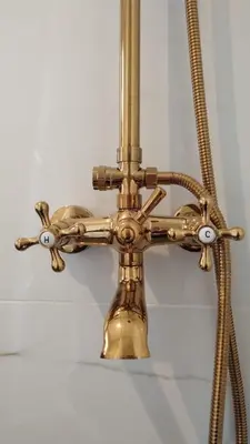 a brass faucet with a hose on a wall at La Flor del Camino Posada in Tanti
