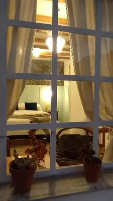 a view of a bedroom through a window at La Flor del Camino Posada in Tanti