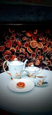 a table with two tea cups and a plate of food at La Flor del Camino Posada in Tanti