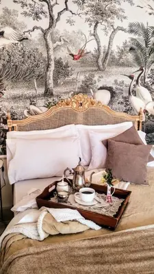 a bed with a tray with a tea set on it at La Flor del Camino Posada in Tanti