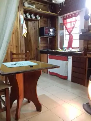 a wooden table in a kitchen with a counter at Cabaña Mateo in Cordoba