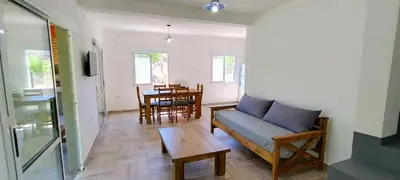 a living room with a couch and a table at Cabañas Madre Sierra in Santa Rosa de Calamuchita