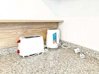 two toasters sitting on a counter in a kitchen at Edificio Darwin in Villa Carlos Paz