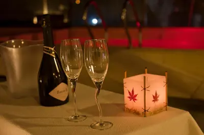 a table with two wine glasses and a bottle of wine at HOTEL CONTINENTAL PLAZA in Villa Carlos Paz
