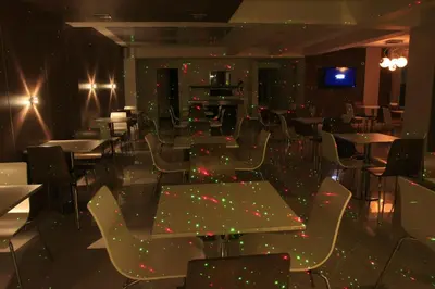 a dining room with tables and chairs and lights at HOTEL CONTINENTAL PLAZA in Villa Carlos Paz