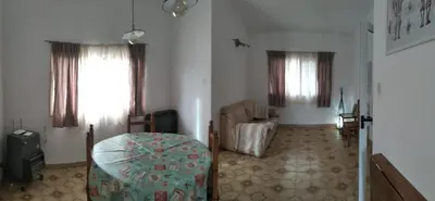 a room with a bed and a chair in a room at Casa/ Villa General Belgrano in Villa General Belgrano