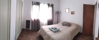 a bedroom with a bed with a blue object on it at Casa/ Villa General Belgrano in Villa General Belgrano