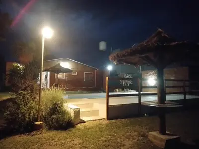 a house at night with a street light and a pool at Sol Naciente in Potrero de Garay