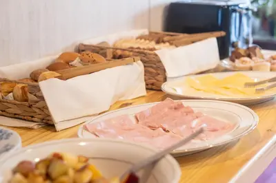 a table topped with plates of food and bread at POSADA NEHUEN in Villa General Belgrano