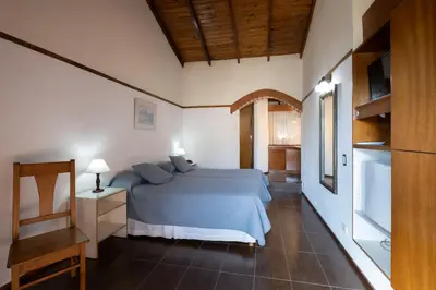a bedroom with a blue bed in a room at POSADA NEHUEN in Villa General Belgrano