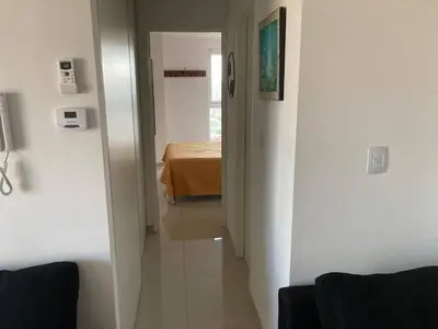 a hallway leading to a bedroom with a bed in a room at TORRES H in Cordoba