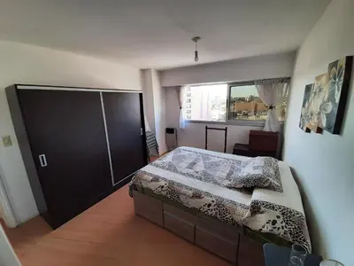 a bedroom with a large bed and a window at Departamento MeR in Río Cuarto