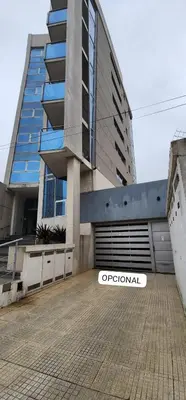 an apartment building with a sign in front of it at Departamento MeR in Río Cuarto