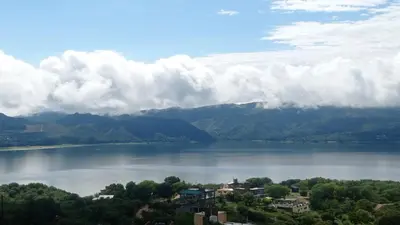 a view of a large body of water with mountains at El Mirador de los Manantiales in Villa Parque Siquiman
