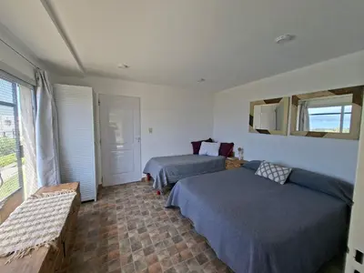a bedroom with two beds and a window at El Mirador de los Manantiales in Villa Parque Siquiman