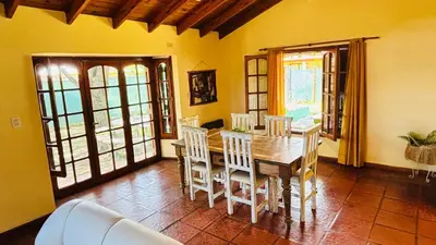 a dining room with a wooden table and chairs at La Casa Nostra in Río Cuarto