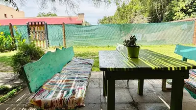 a picnic table and bench with a potted plant on a patio at La Casa Nostra in Río Cuarto