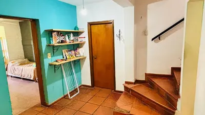 a hallway with a door and stairs in a room at La Casa Nostra in Río Cuarto