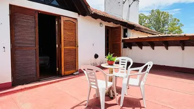 two white chairs and a table on a patio at La Casa Nostra in Río Cuarto
