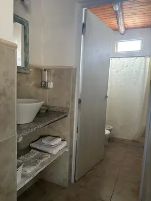 a bathroom with a sink and a toilet at Cardozo House Monoambiente acogedor y familiar in Villa Dolores