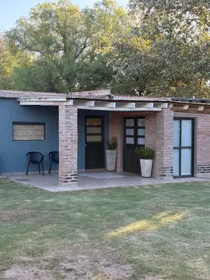 a brick house with a porch and a patio at Cardozo House Monoambiente acogedor y familiar in Villa Dolores