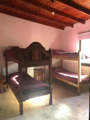 a bedroom with two bunk beds in a room at Casa en Santa Rosa de Calamuchita in Santa Rosa de Calamuchita