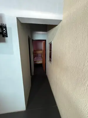 a hallway leading to a room with a bed at Romedeptos II in Merlo