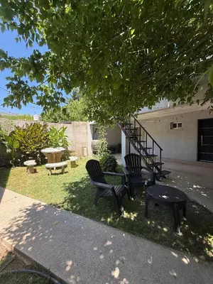 two chairs and a table under a tree at Romedeptos II in Merlo