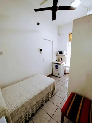a bedroom with a bed and a ceiling fan at Habitacion con baño privado in Cordoba