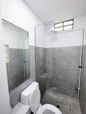 a bathroom with a toilet and a glass shower at Habitacion con baño privado in Cordoba