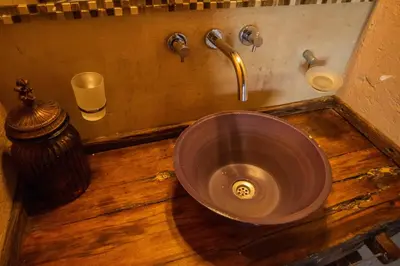 a bathroom sink with a copper bowl in the middle at Brisas de Chacras in San Javier